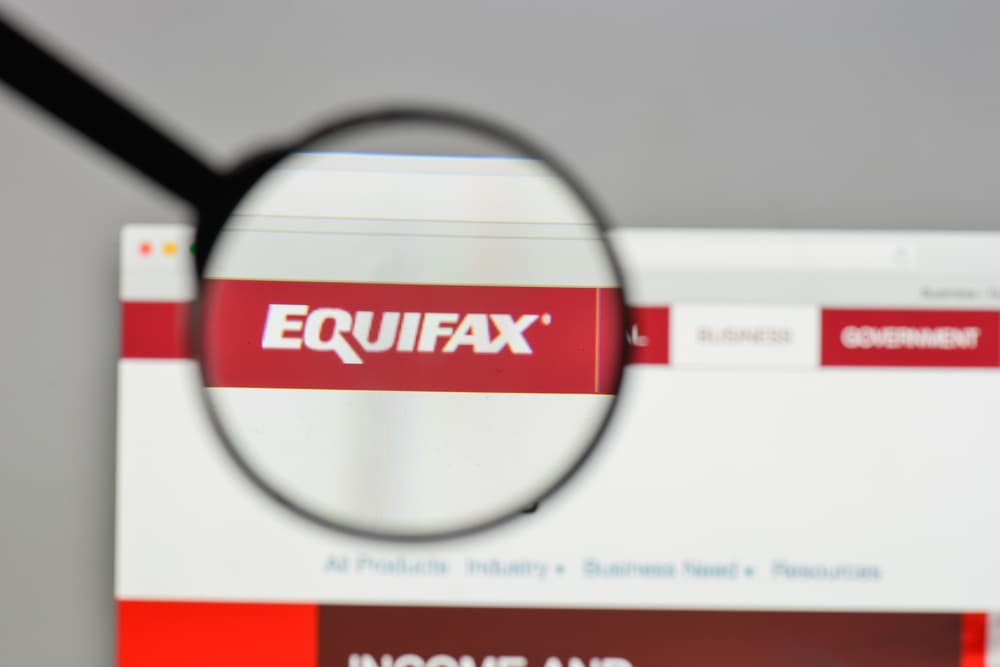 Equifax logo seen on magnifying glass
