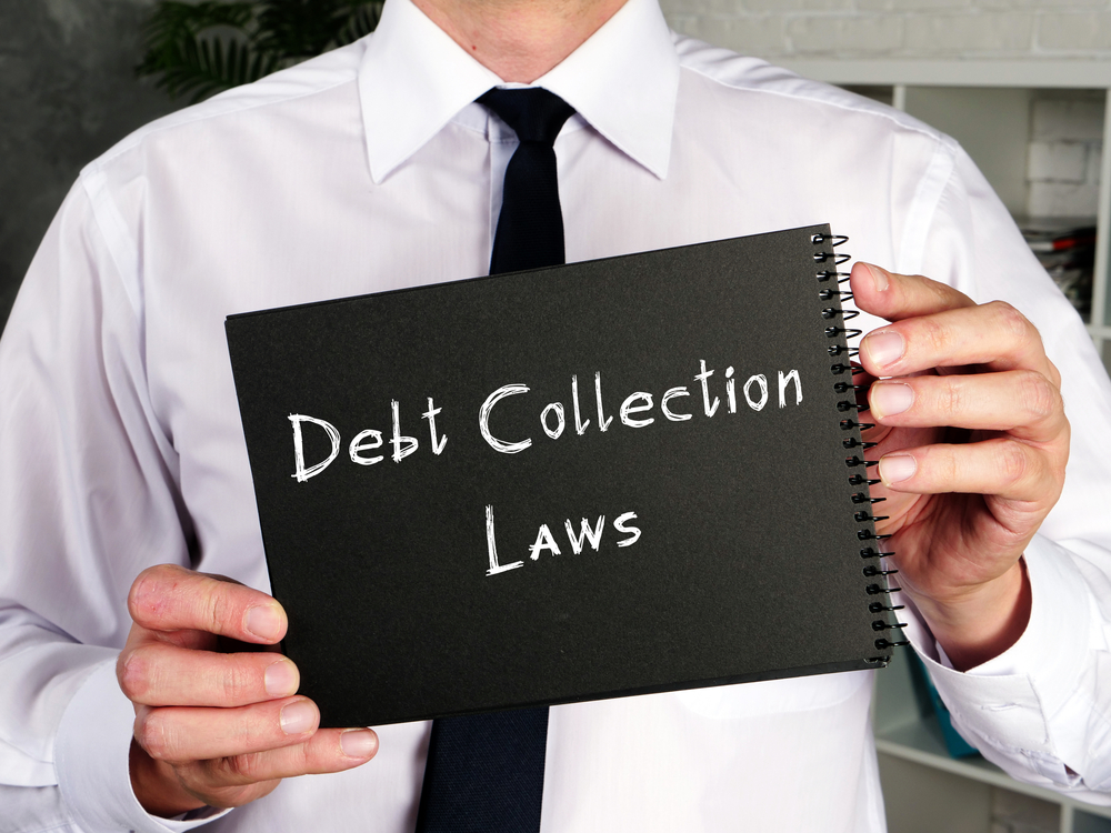 Business concept regarding Debt Collection Laws, illustrated with a sign on a piece of paper.