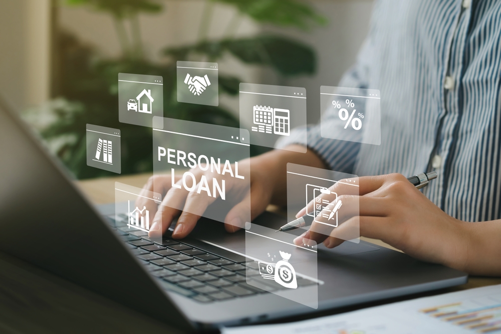 Woman using a computer with personal loan icons on a virtual screen, highlighting 'Personal Loan' in a modern, tech-savvy setting.