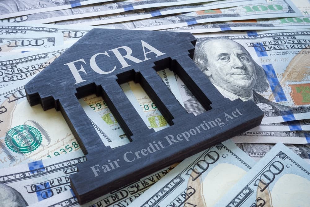 FCRA symbol on dollar bills represents legal protection against unlawful practices affecting credit rights.